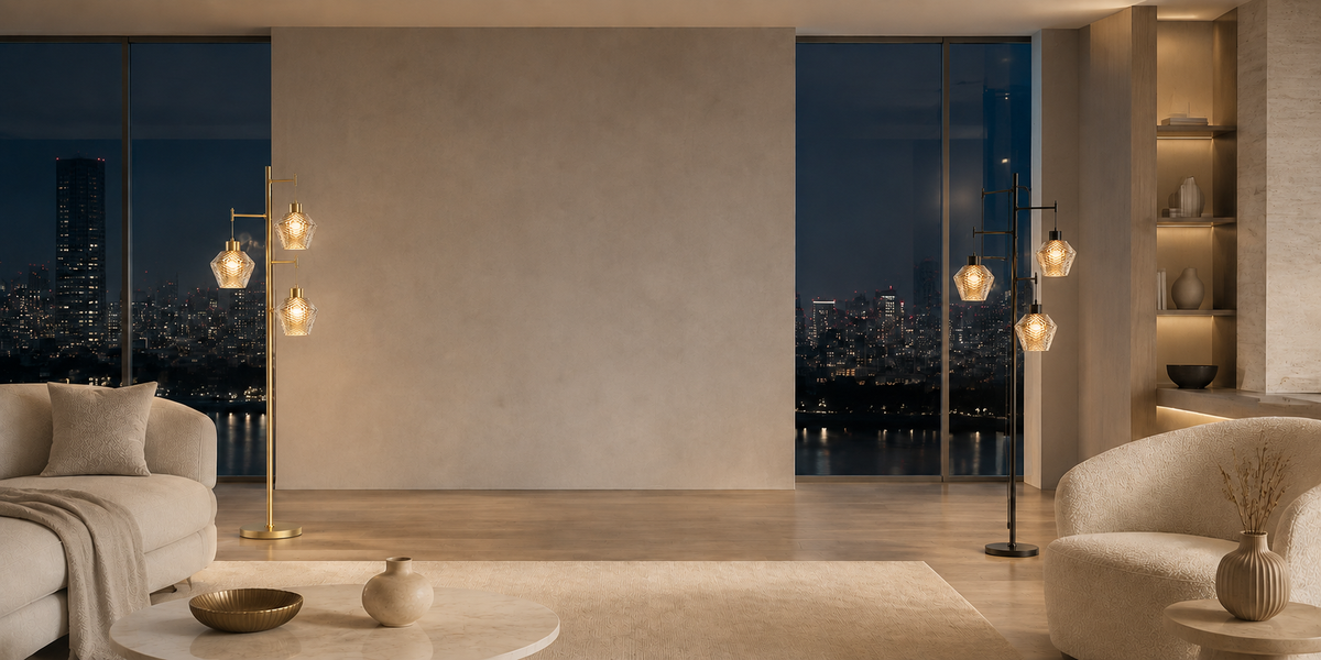Gold and black Vintora floor lamps in a bright modern apartment overlooking the city at night